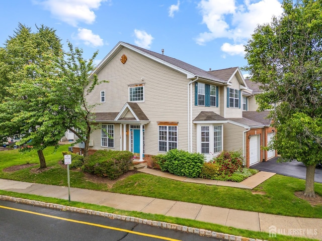 19 Grossweiler Ln, Parlin, NJ 08859 - townhome / multi-family property featuring a front lawn, a garage, and driveway