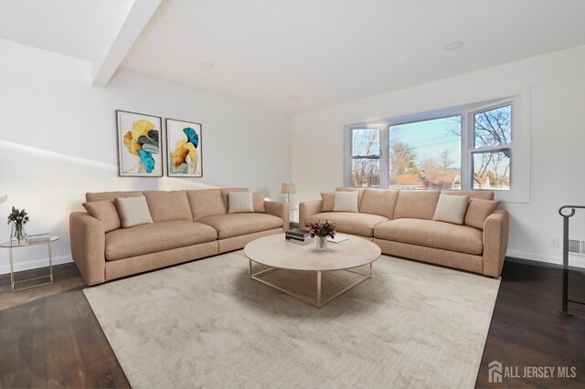 living room with hardwood / wood-style flooring and beamed ceiling