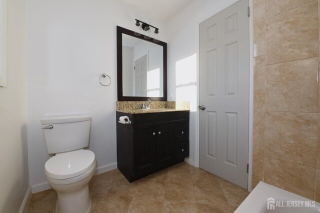 bathroom with toilet and vanity