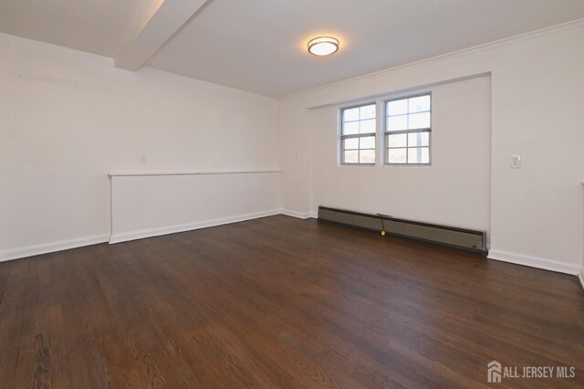 spare room with baseboard heating, dark hardwood / wood-style flooring, and beam ceiling