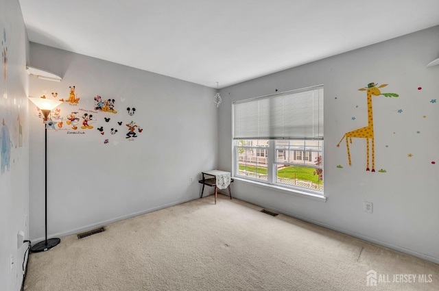 carpeted spare room featuring baseboards