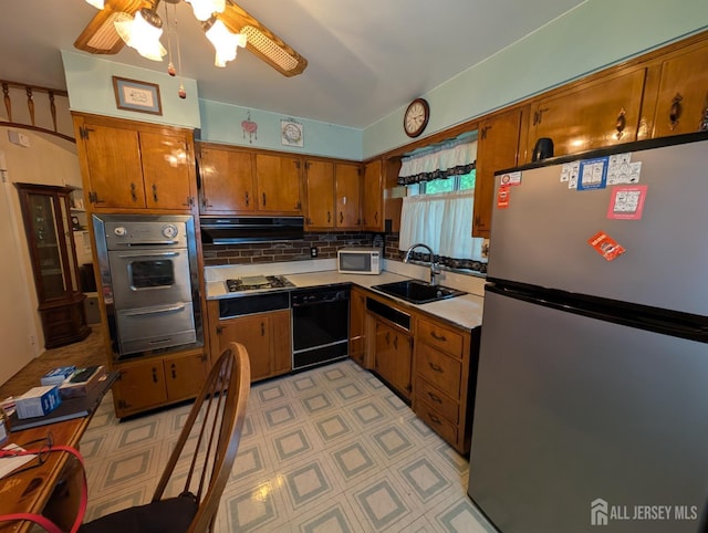 28 Tanglewood Ln, East Brunswick, NJ 08816 - kitchen with appliances with stainless steel finishes, a sink, a warming drawer, brown cabinets, and exhaust hood