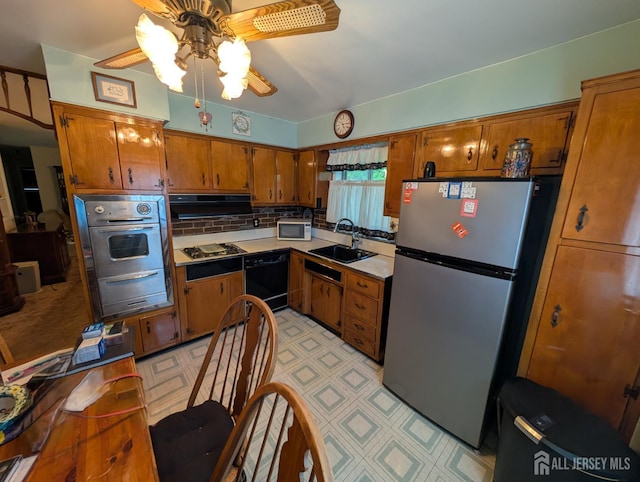 28 Tanglewood Ln, East Brunswick, NJ 08816 - kitchen featuring appliances with stainless steel finishes, a sink, brown cabinetry, a warming drawer, and ceiling fan