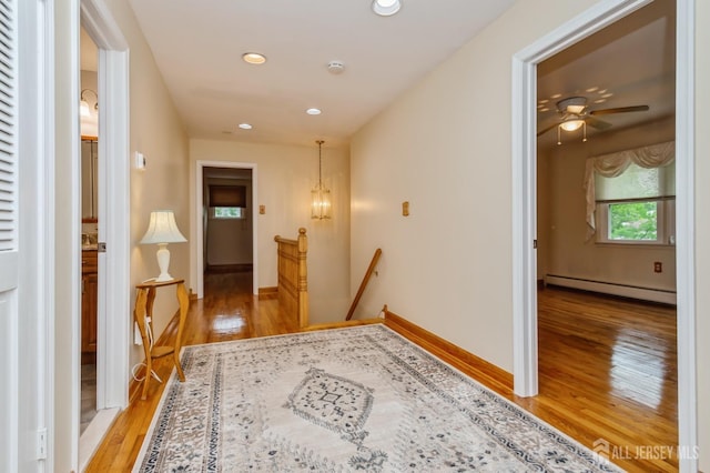 27 Briarwood Dr, Old Bridge, NJ 07747 - corridor featuring an upstairs landing, a baseboard heating unit, light wood-style flooring, recessed lighting, and baseboards