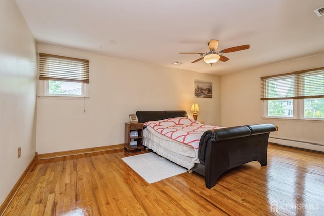 27 Briarwood Dr, Old Bridge, NJ 07747 - bedroom with light wood finished floors, a baseboard radiator, a ceiling fan, and baseboards