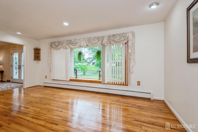 27 Briarwood Dr, Old Bridge, NJ 07747 - spare room featuring a baseboard heating unit, wood finished floors, baseboard heating, baseboards, and recessed lighting