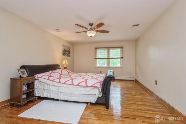 27 Briarwood Dr, Old Bridge, NJ 07747 - bedroom featuring baseboard heating, light wood-type flooring, baseboards, and a ceiling fan