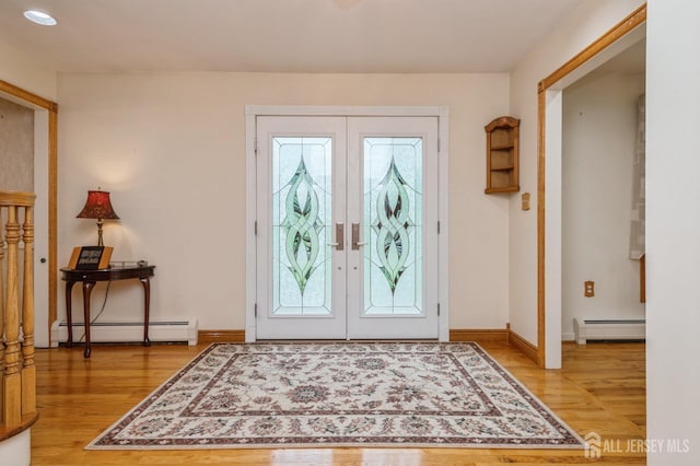 27 Briarwood Dr, Old Bridge, NJ 07747 - entryway featuring a baseboard heating unit, light wood-style floors, and french doors