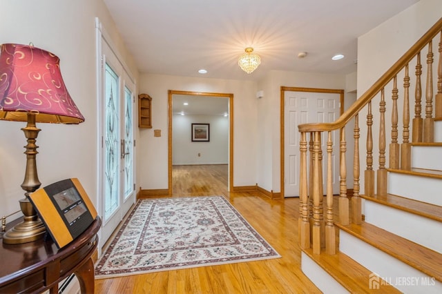 27 Briarwood Dr, Old Bridge, NJ 07747 - entryway featuring wood finished floors, stairway, baseboards, recessed lighting, and a chandelier