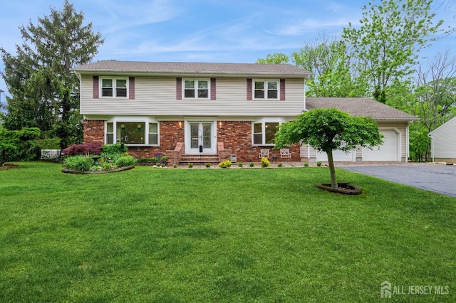 27 Briarwood Dr, Old Bridge, NJ 07747 - colonial house featuring driveway, a garage, a front yard, and entry steps