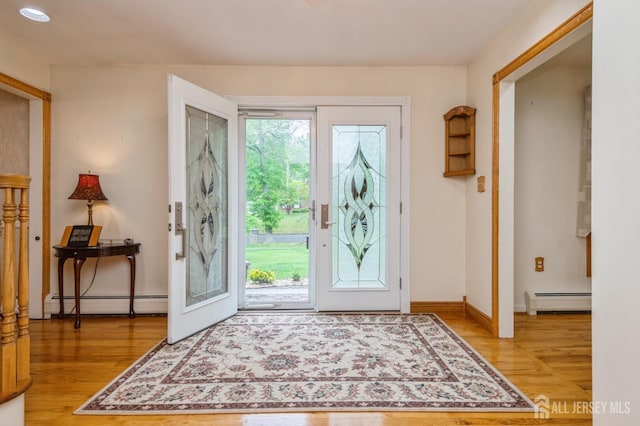 27 Briarwood Dr, Old Bridge, NJ 07747 - foyer featuring a baseboard radiator, healthy amount of natural light, and light wood-style floors