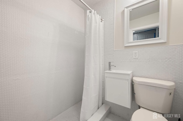 bathroom with tiled shower and toilet