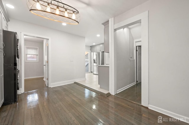 interior space with recessed lighting, dark wood finished floors, and baseboards