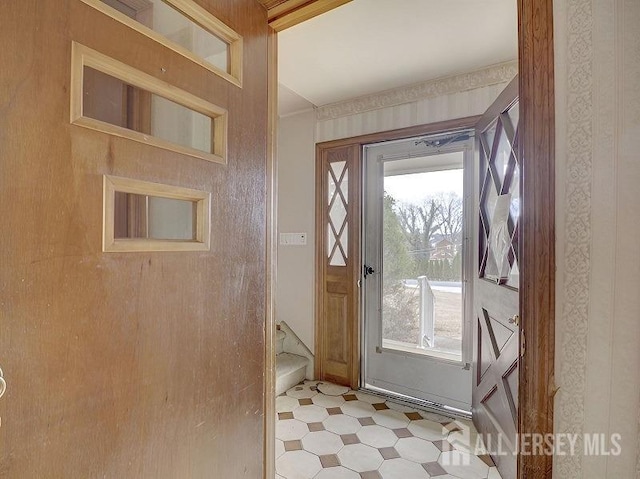 doorway featuring tile patterned floors and plenty of natural light