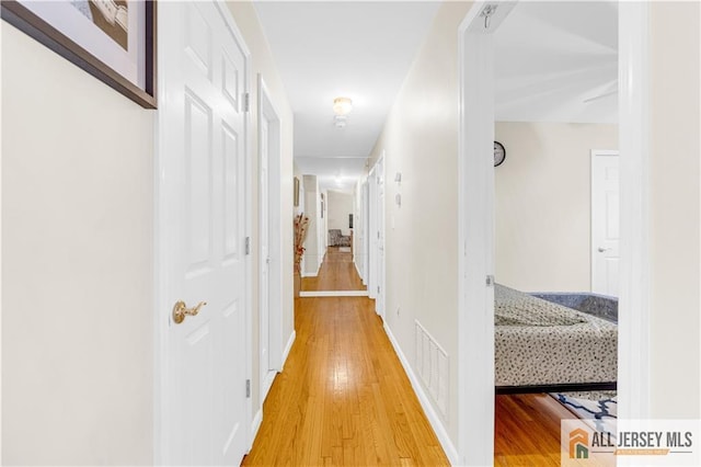 21 Wilk Rd, Edison, NJ 08837 - corridor featuring light wood-style floors and baseboards