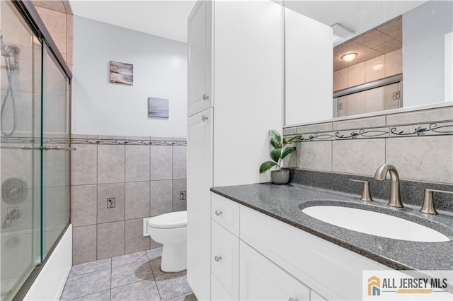 21 Wilk Rd, Edison, NJ 08837 - bathroom featuring tile walls, vanity, enclosed tub / shower combo, and tile patterned flooring