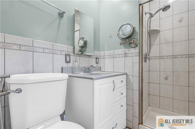 21 Wilk Rd, Edison, NJ 08837 - bathroom with a stall shower, tile walls, vanity, and a wainscoted wall