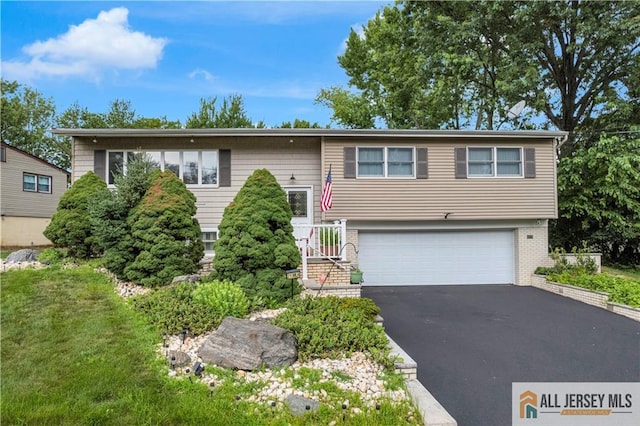 21 Wilk Rd, Edison, NJ 08837 - bi-level home featuring an attached garage, driveway, and brick siding