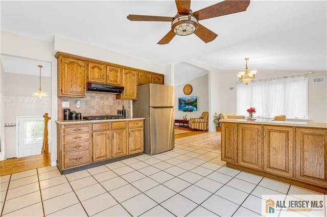 21 Wilk Rd, Edison, NJ 08837 - kitchen featuring freestanding refrigerator, light tile patterned floors, tasteful backsplash, hanging light fixtures, and a chandelier