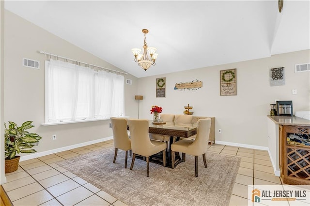 21 Wilk Rd, Edison, NJ 08837 - dining area featuring light tile patterned floors, lofted ceiling, and a chandelier