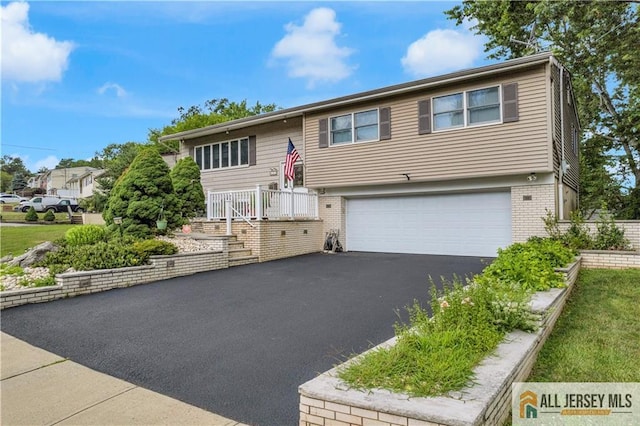 21 Wilk Rd, Edison, NJ 08837 - bi-level home featuring brick siding, a garage, and driveway