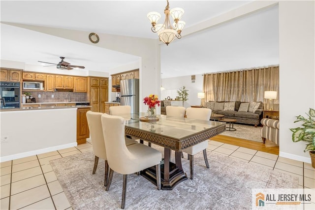 21 Wilk Rd, Edison, NJ 08837 - dining area with light tile patterned floors, a ceiling fan, and a chandelier