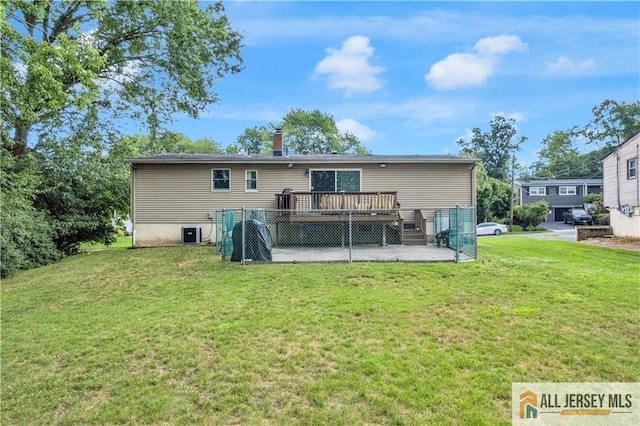 21 Wilk Rd, Edison, NJ 08837 - rear view of house featuring a wooden deck, a lawn, a chimney, and a patio