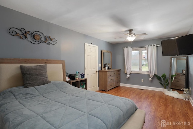 bedroom with light hardwood / wood-style floors and ceiling fan