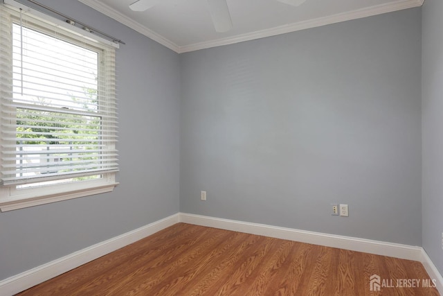 unfurnished room with crown molding, a healthy amount of sunlight, and wood-type flooring