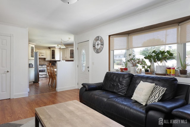 living room featuring hardwood / wood-style flooring and ornamental molding