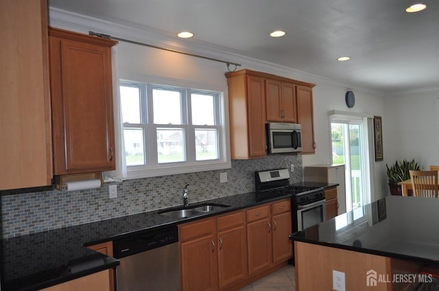 12 Sunny Ct, Monroe, NJ 08831 - kitchen featuring appliances with stainless steel finishes, a sink, ornamental molding, tasteful backsplash, and brown cabinetry