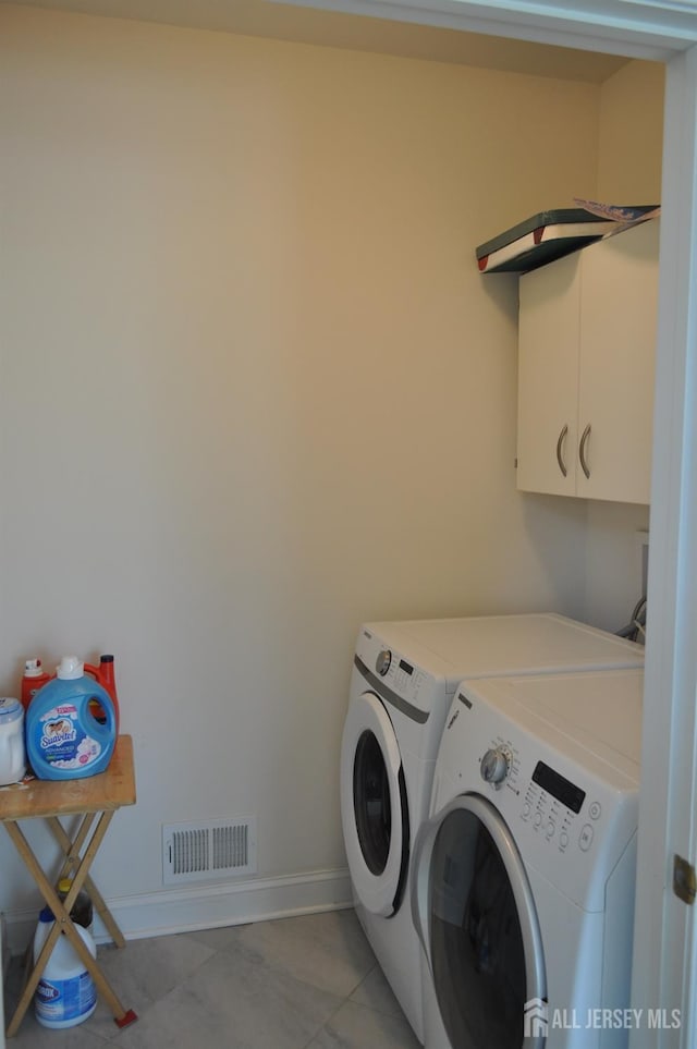 12 Sunny Ct, Monroe, NJ 08831 - washroom featuring washer and clothes dryer, cabinet space, light tile patterned floors, and baseboards