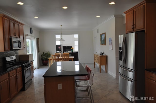 12 Sunny Ct, Monroe, NJ 08831 - kitchen with appliances with stainless steel finishes, dark countertops, a breakfast bar area, recessed lighting, and a center island