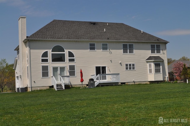 12 Sunny Ct, Monroe, NJ 08831 - rear view of house featuring a chimney, a yard, central AC, and a wooden deck