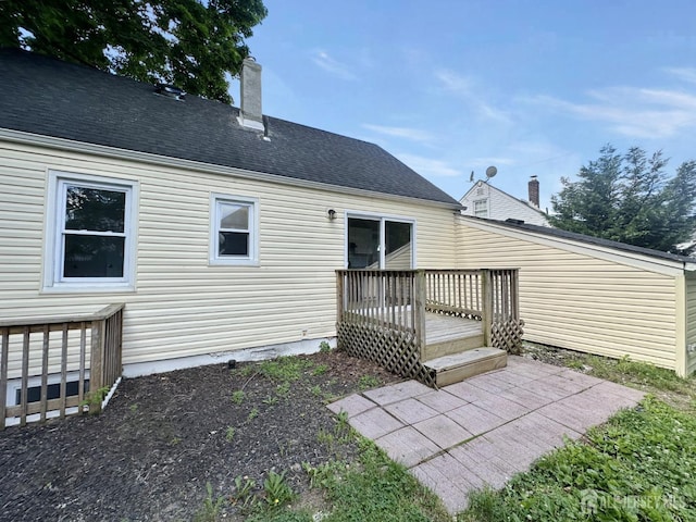 rear view of property featuring a deck and a patio