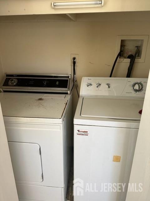 laundry room featuring washing machine and clothes dryer