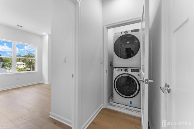 243 E 9th Ave, Roselle, NJ 07203 - washroom with estacked washer and dryer and wood finished floors