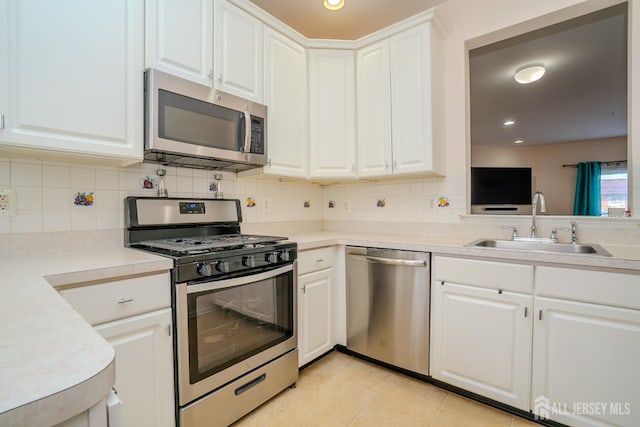 908 Blossom Cir S, Brunswick, NJ 08810 - kitchen featuring stainless steel appliances, light countertops, tasteful backsplash, white cabinetry, and light tile patterned floors