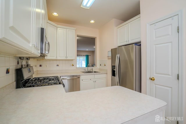 908 Blossom Cir S, Brunswick, NJ 08810 - kitchen featuring stainless steel appliances, light countertops, backsplash, white cabinetry, and recessed lighting