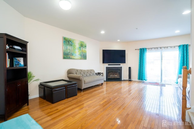 908 Blossom Cir S, Brunswick, NJ 08810 - living room with light wood-style floors, a glass covered fireplace, and recessed lighting