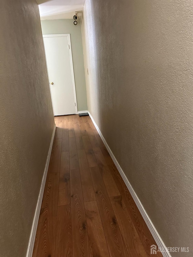 hall with hardwood / wood-style flooring