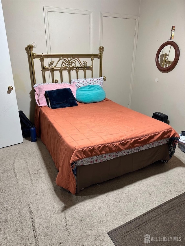 bedroom featuring light colored carpet