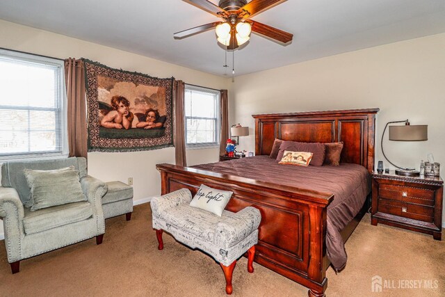 bedroom featuring light colored carpet and ceiling fan