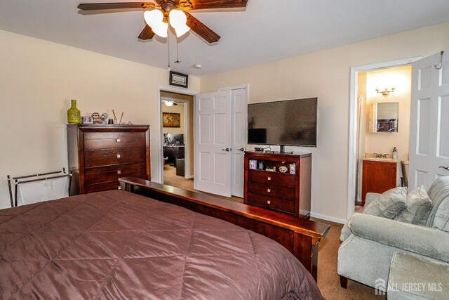 bedroom with ensuite bath and ceiling fan