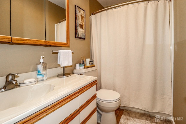 bathroom with tile patterned flooring, vanity, and toilet