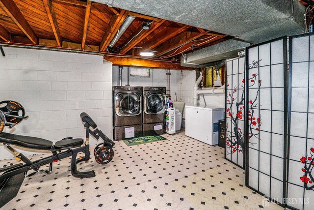 washroom with washing machine and clothes dryer and sink