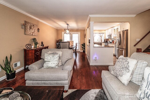 living room featuring ornamental molding and dark hardwood / wood-style floors