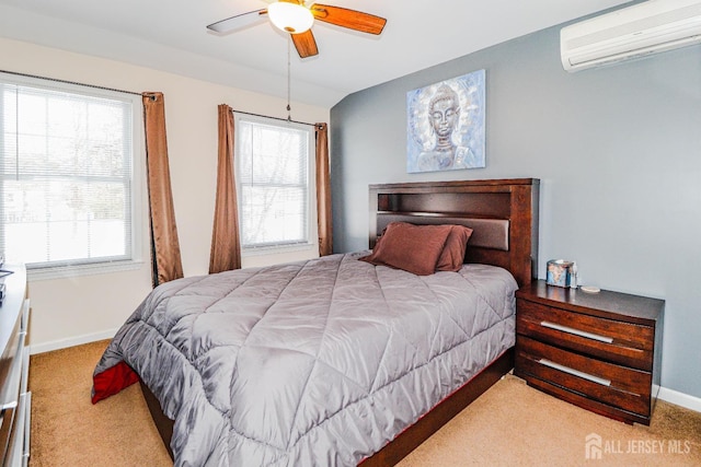 carpeted bedroom with ceiling fan and a wall unit AC