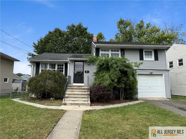 view of front of property featuring a garage and a front lawn