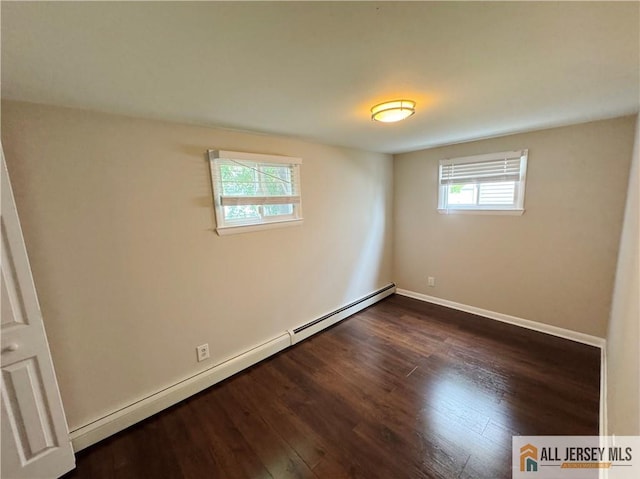 unfurnished room featuring dark wood-type flooring and a baseboard radiator